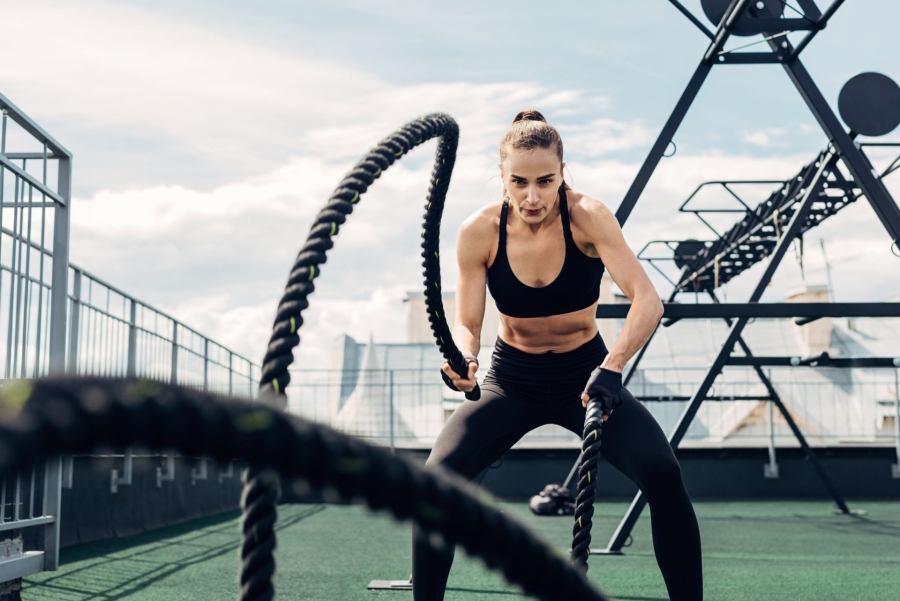 fit woman with battle ropes