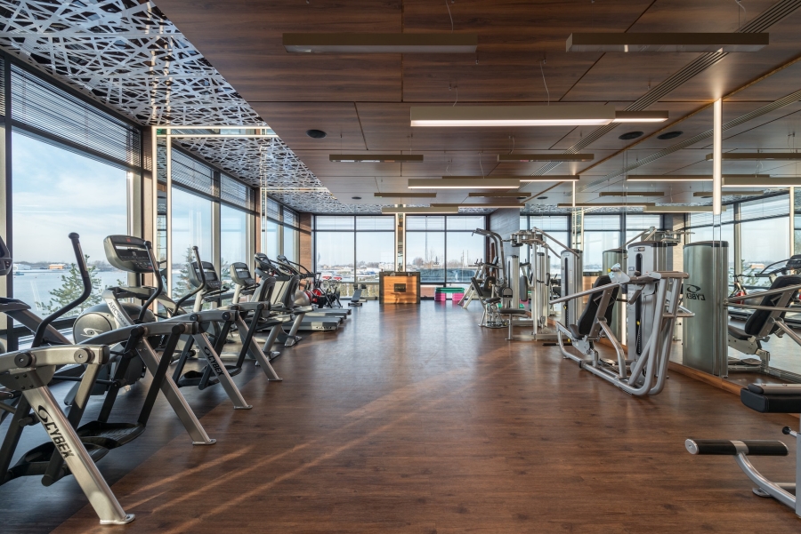 Various fitness machines in modern spacious gym